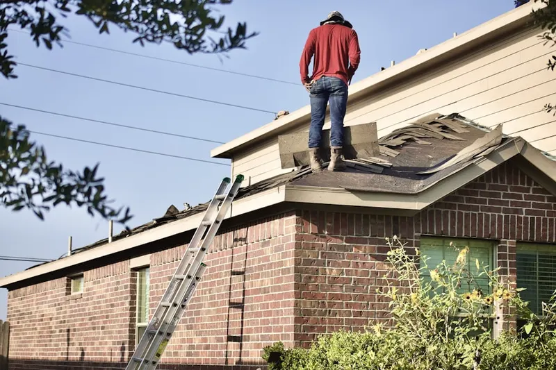 Professional roofer working on a residential roof in Thorndale